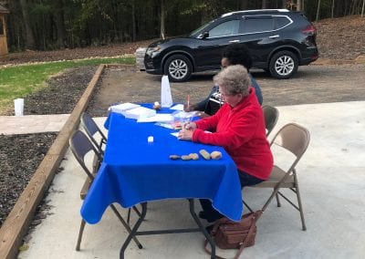 Elderly woman writing in desk